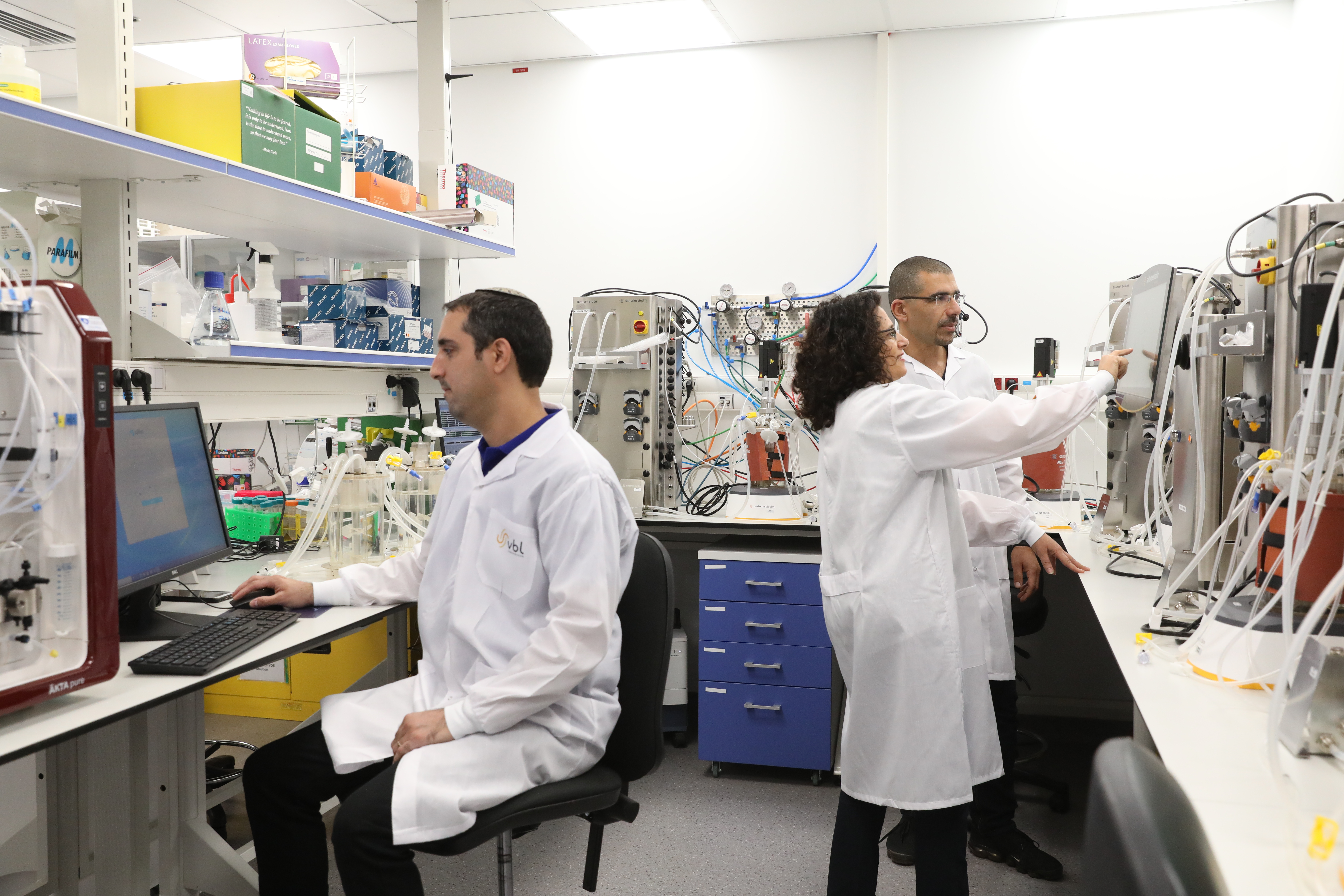 Lab technicians in lab hoodies, working in VBL’s facility in Modiin, Israel.